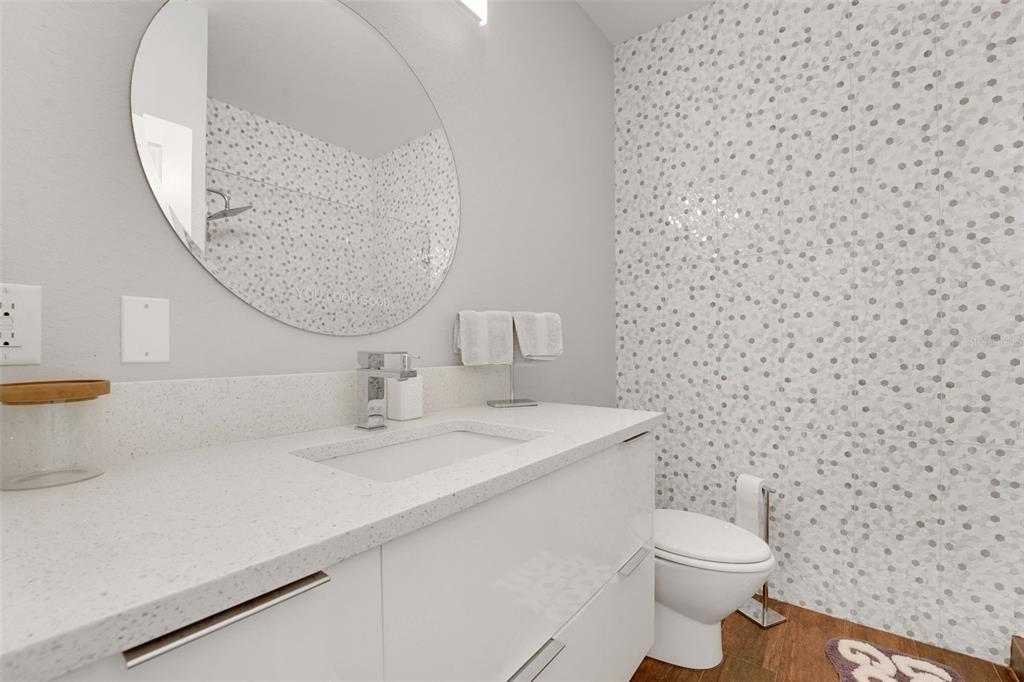 5911 Old Berkley Road Auburndale, FL 33823 - Photo 55 of 91 a bathroom with a sink a toilet and a mirror