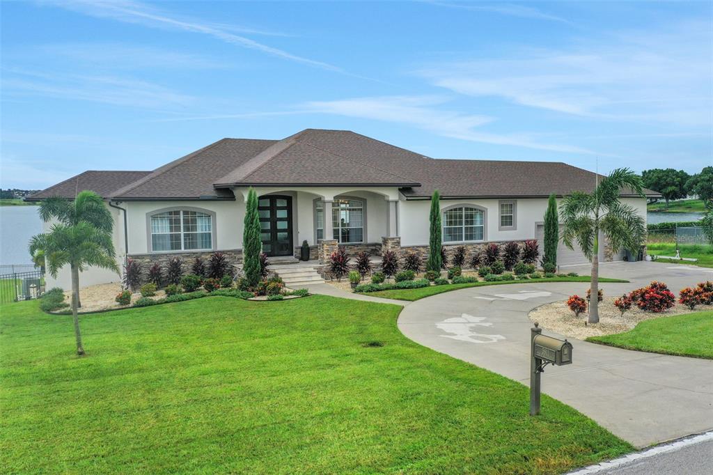 5911 Old Berkley Road Auburndale, FL 33823 - Photo 84 of 91 a front view of a house with a garden