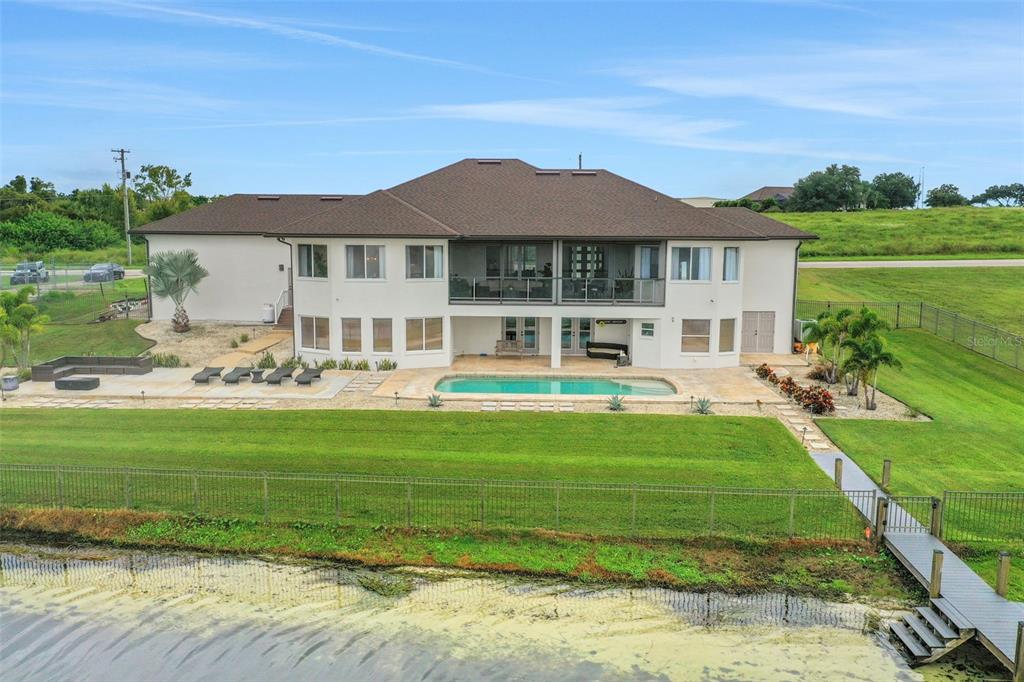 5911 Old Berkley Road Auburndale, FL 33823 - Photo 87 of 91 a front view of a house with a yard table and chairs