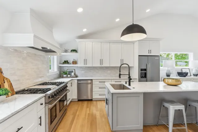 a kitchen with a sink a stove and chairs
