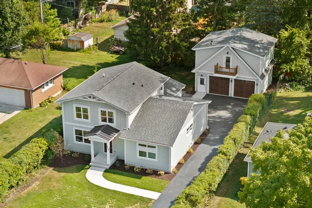 an aerial view of a house with a yard