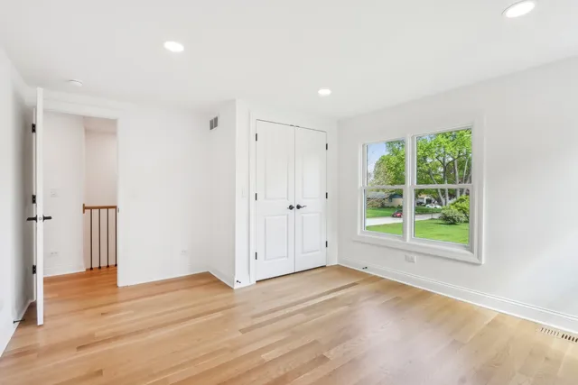 a view of a room with wooden floor and window