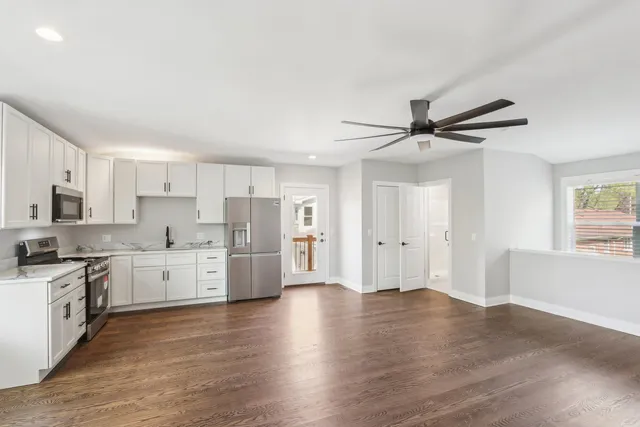 a kitchen with a stove a sink and a refrigerator