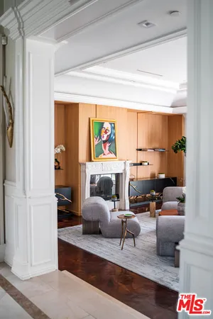 a very nice looking living room with a couch and a potted plant