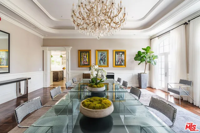 a living room with furniture dining table and a potted plant