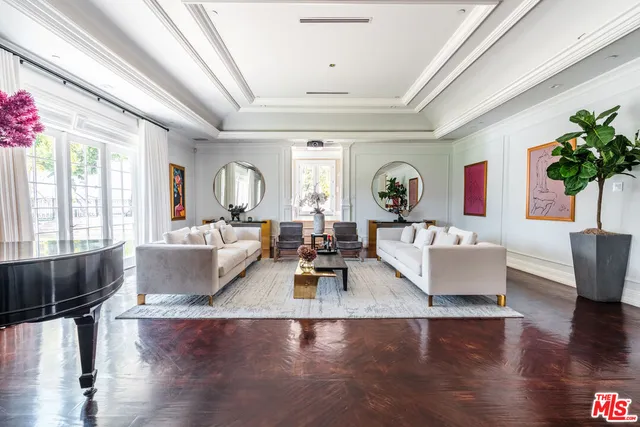a living room with furniture and flowers