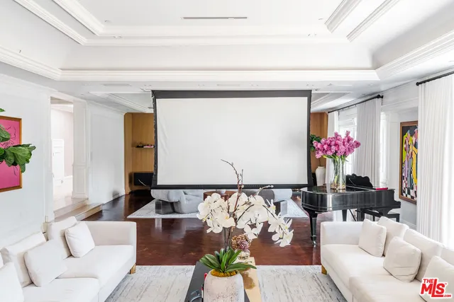 a kitchen with stainless steel appliances a stove a chimney a sink and a chandelier