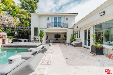 a view of a house with garden and sitting area