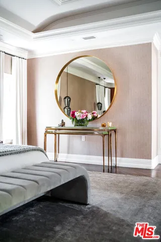 a view of a dining room with furniture and flowers
