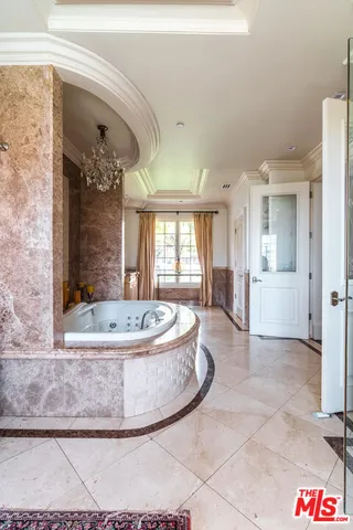 a bedroom with a bed and large window