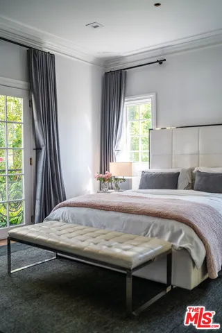 a living room with furniture and flowers