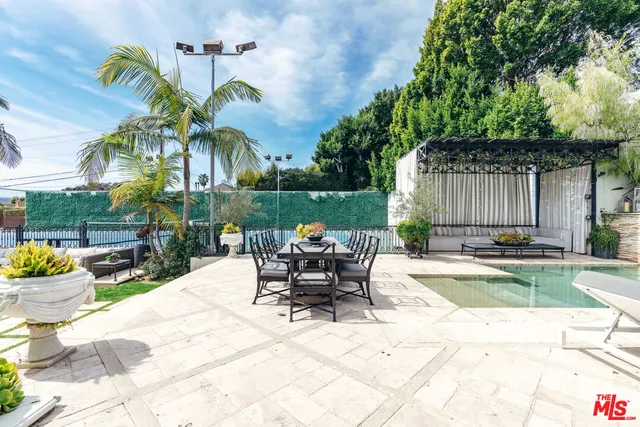 a view of a patio with a table and chairs