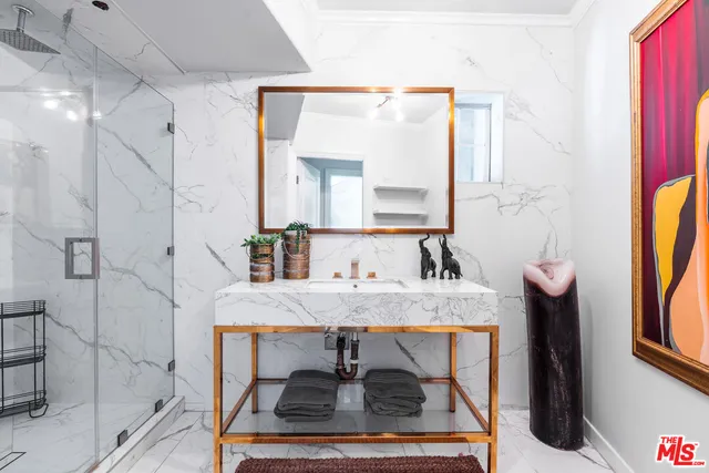 a bedroom with a bed lamp and a large window