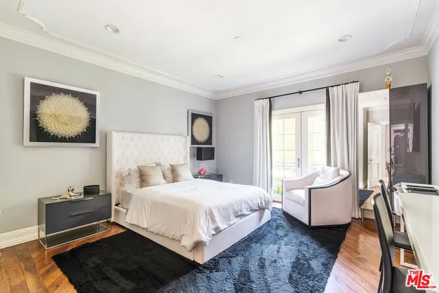 a bedroom with furniture and a large window