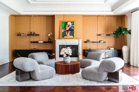 a living room with furniture fireplace and a window