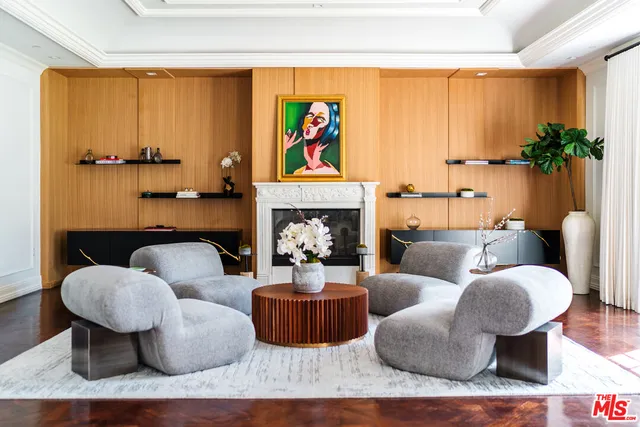 a living room with furniture fireplace and a window