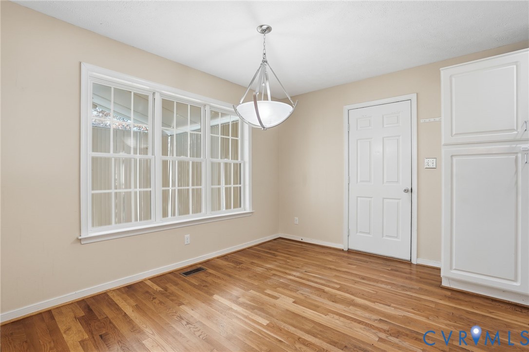 6093 Homehills Road Mechanicsville, VA 23111 - Photo 11 of 50 a view of a room with wooden floor and windows