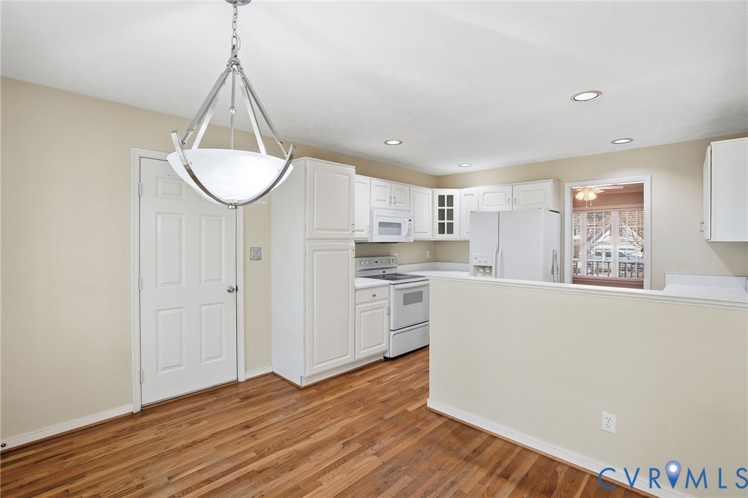 6093 Homehills Road Mechanicsville, VA 23111 - Photo 12 of 50 a kitchen with a refrigerator a sink and cabinets