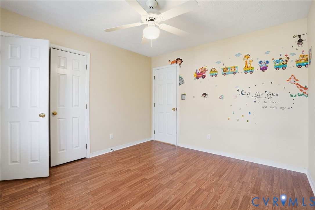 6093 Homehills Road Mechanicsville, VA 23111 - Photo 34 of 50 an empty room with an empty space and wooden floor