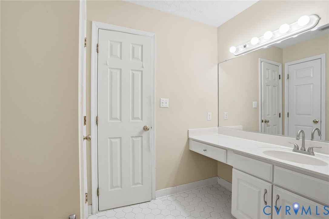 6093 Homehills Road Mechanicsville, VA 23111 - Photo 38 of 50 a bathroom with a sink and a mirror