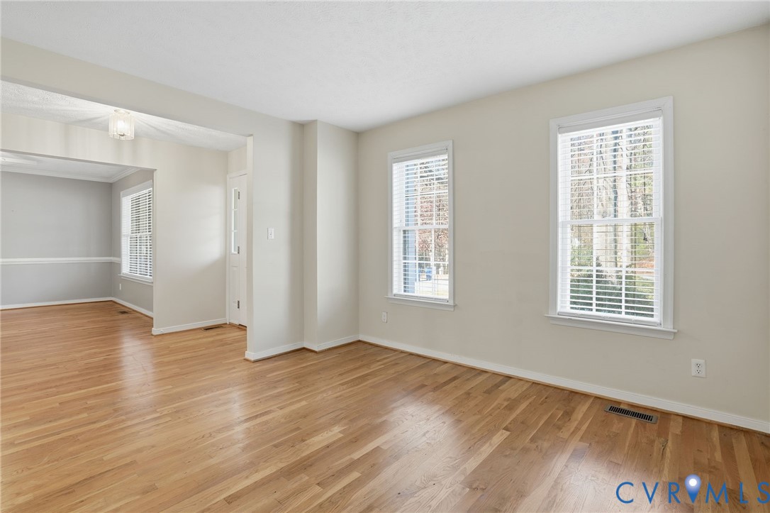 6093 Homehills Road Mechanicsville, VA 23111 - Photo 6 of 50 a view of an empty room with wooden floor and a window