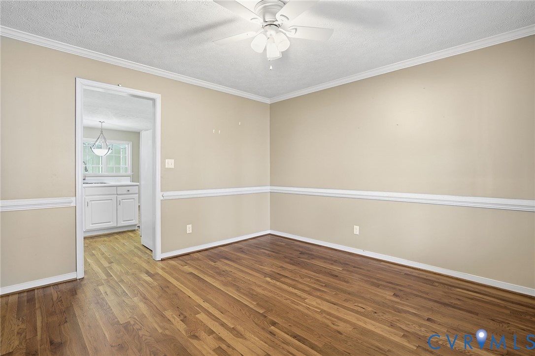 6093 Homehills Road Mechanicsville, VA 23111 - Photo 8 of 50 an empty room with wooden floor cabinet and windows