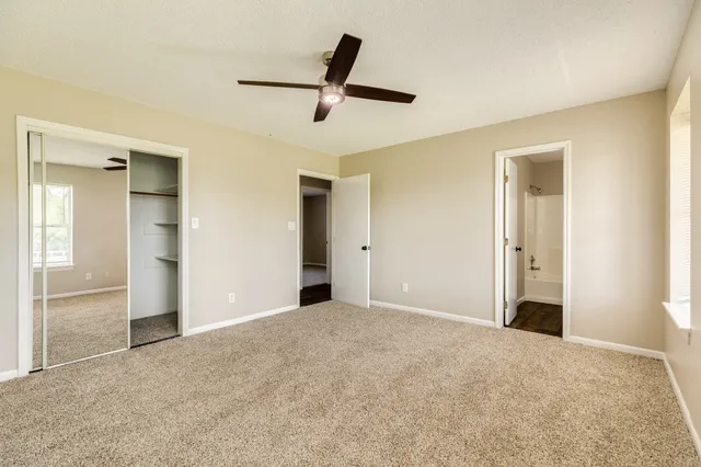 a view of a livingroom with a ceiling fan and window