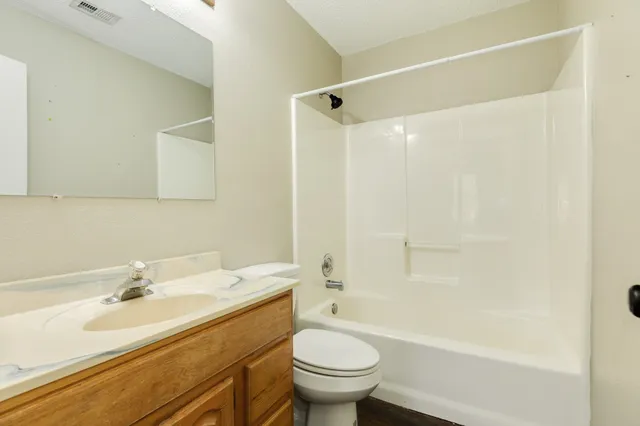 a bathroom with a sink toilet vanity and shower