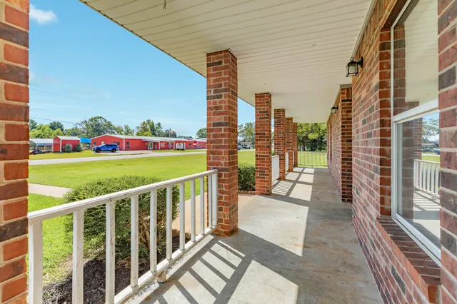 a view of a balcony with yard