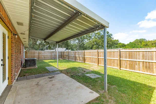 a view of a backyard with fence