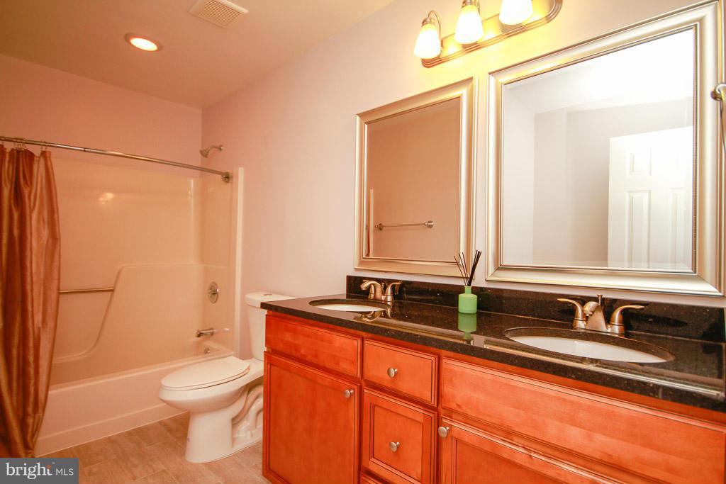 606 Rivershore Court Edgewood, MD 21040 - Photo 23 of 26 a bathroom with a sink a toilet and shower