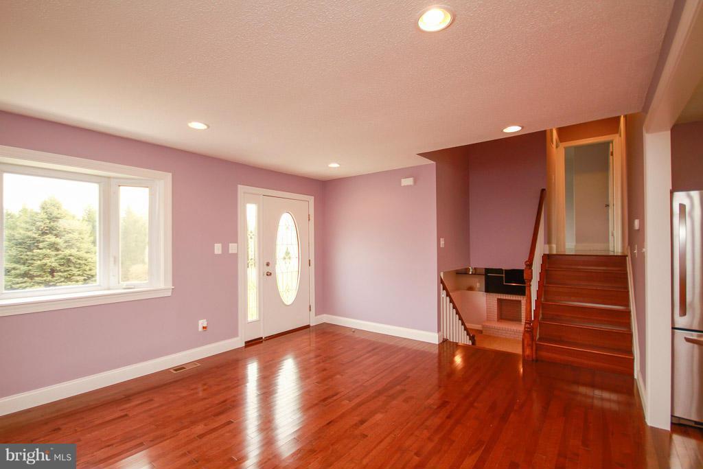 606 Rivershore Court Edgewood, MD 21040 - Photo 4 of 26 a view of an empty room with wooden floor and a window