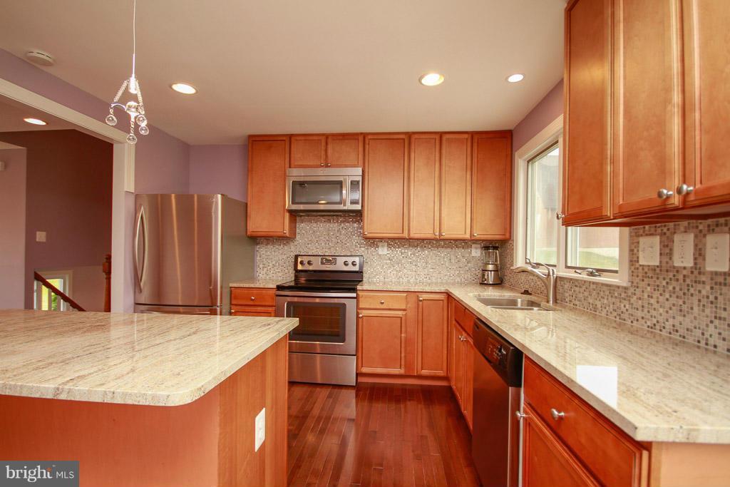 606 Rivershore Court Edgewood, MD 21040 - Photo 8 of 26 a kitchen with stainless steel appliances granite countertop a sink stove refrigerator and cabinets