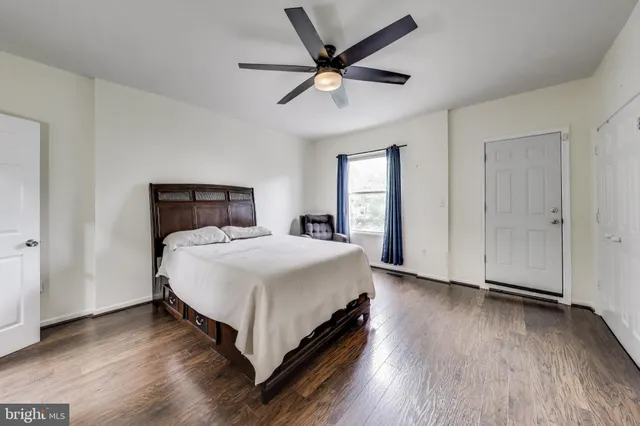 a bedroom with a bed and a ceiling fan