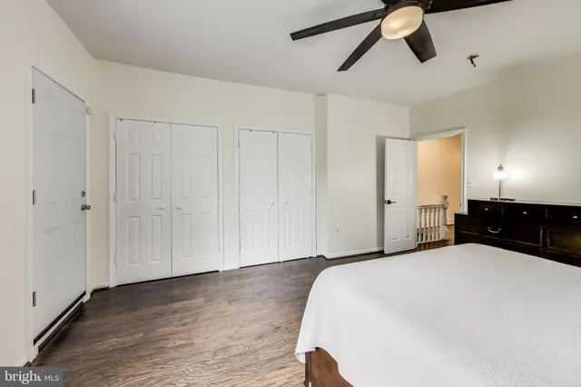 a large bedroom with a bed and wooden floor