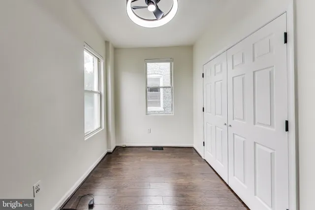 wooden floor in an empty room with a window