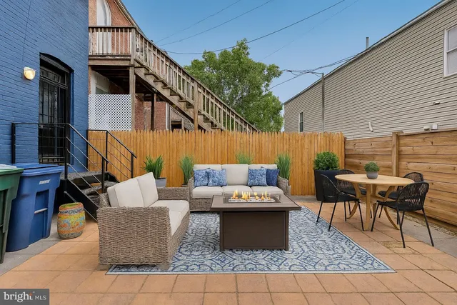 a view of a couches and dinning table in patio