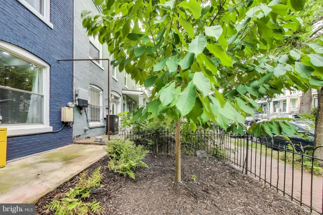 a view of a room with a white wall and a window