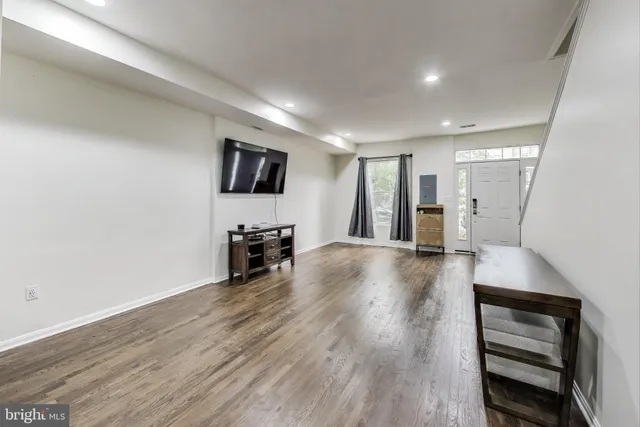 a view of a livingroom with furniture and an empty room