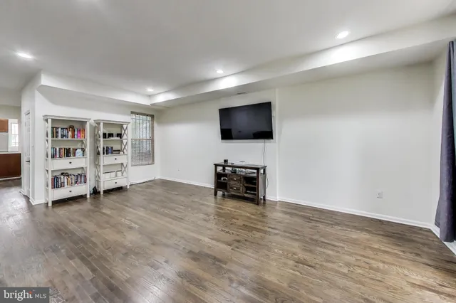 a view of a livingroom with furniture and cabinet with wooden floor