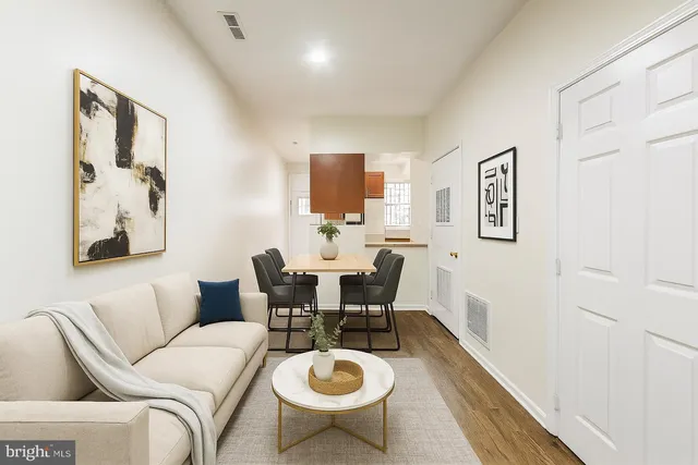 a living room with furniture a couch and wooden floor