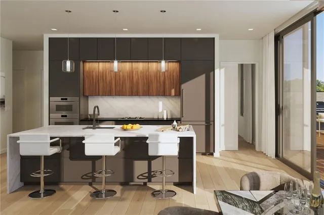 a kitchen with a table chairs refrigerator and cabinets