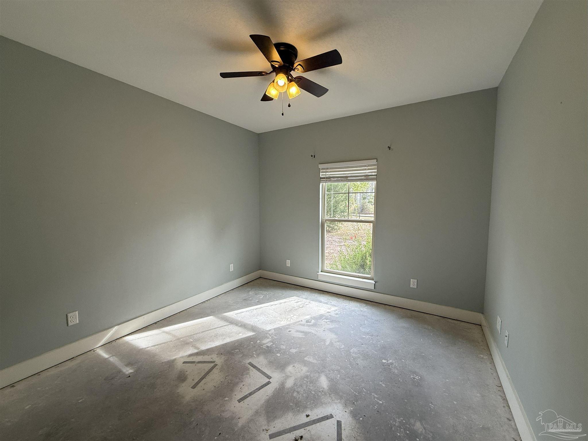 7223 Martin Road Milton, FL 32570 - Photo 13 of 28 an empty room with a window and a ceiling fan