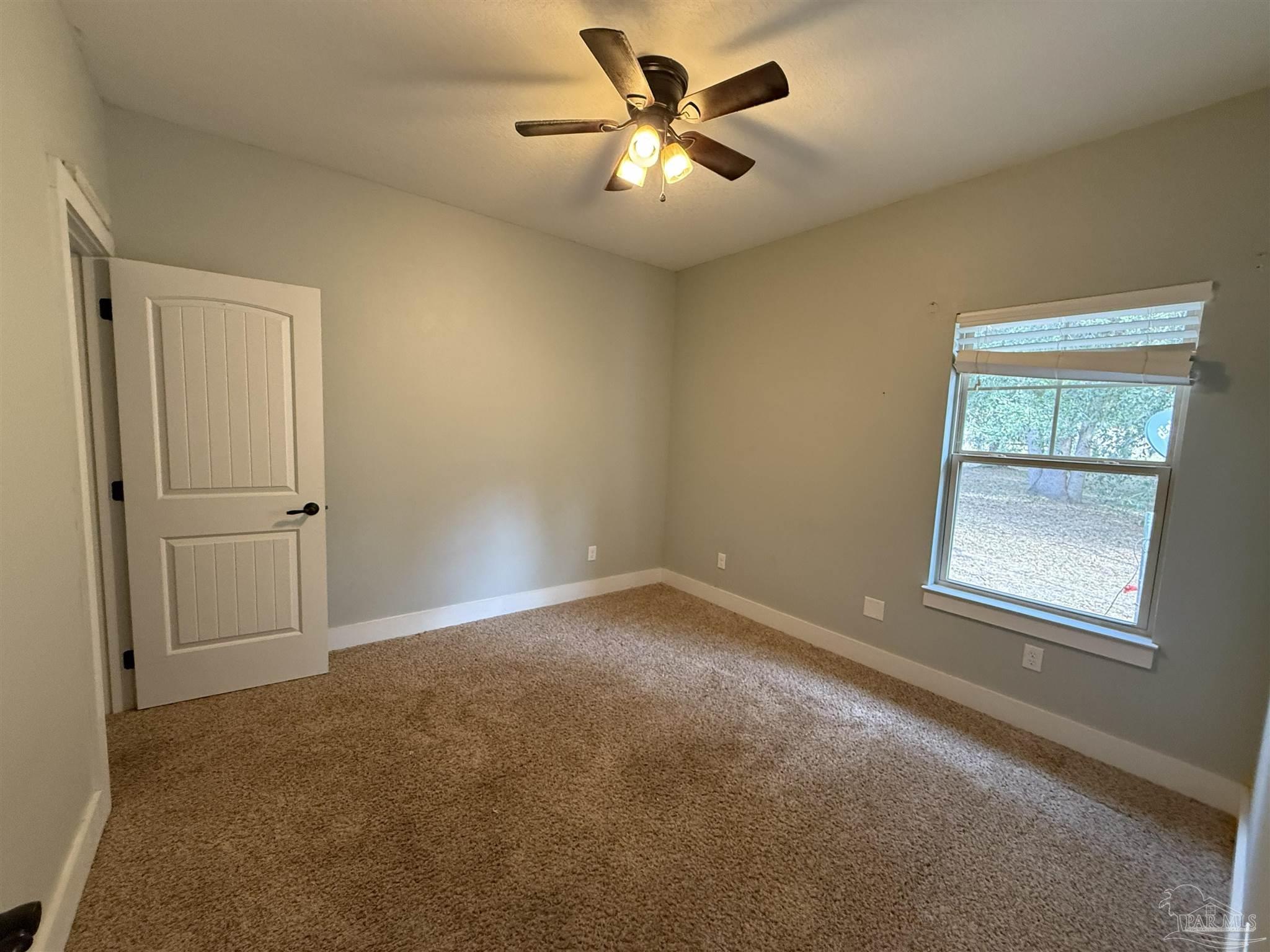 7223 Martin Road Milton, FL 32570 - Photo 15 of 28 an empty room with windows and fan