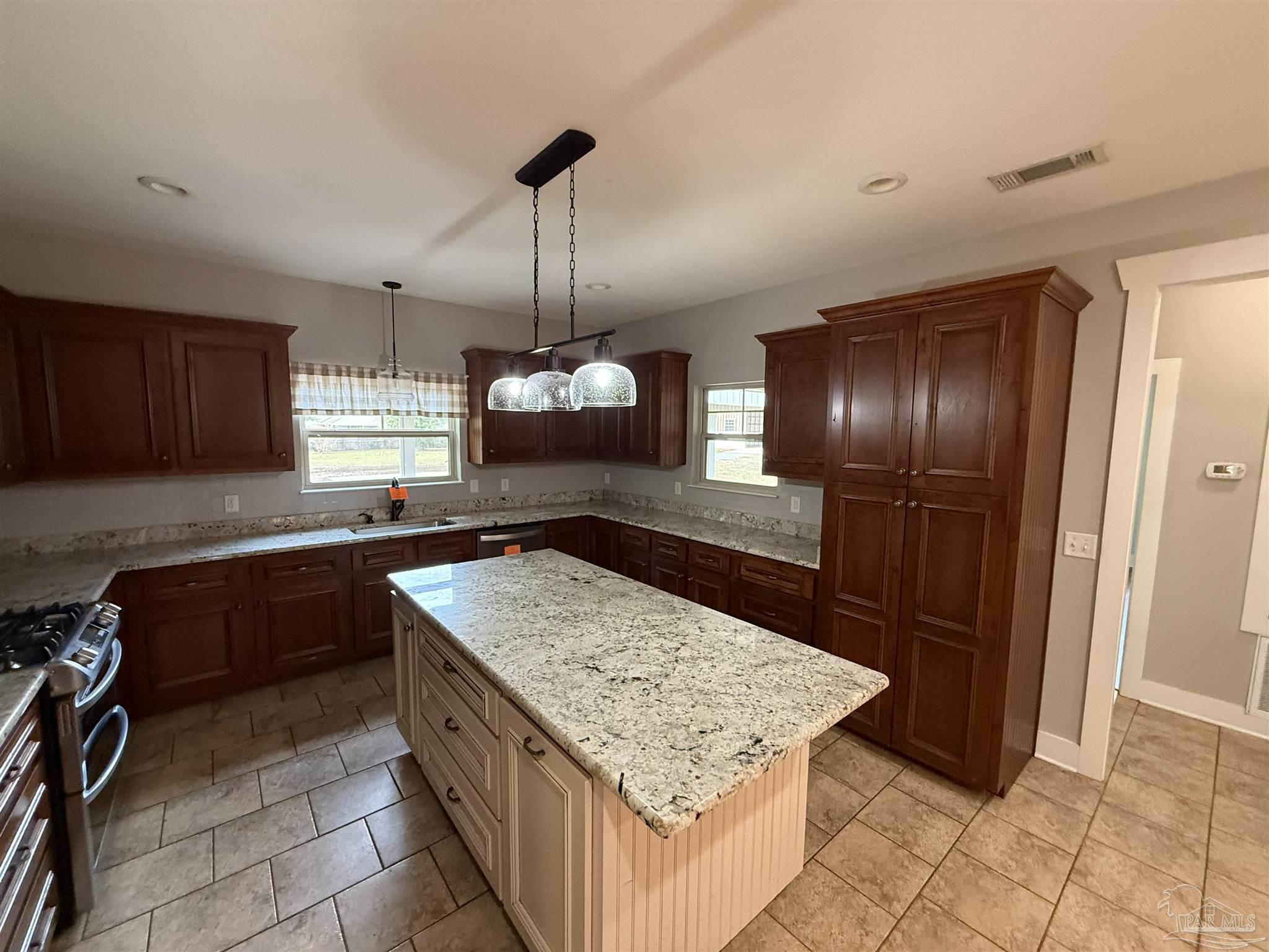 7223 Martin Road Milton, FL 32570 - Photo 17 of 28 a kitchen with stainless steel appliances granite countertop cabinets and refrigerator