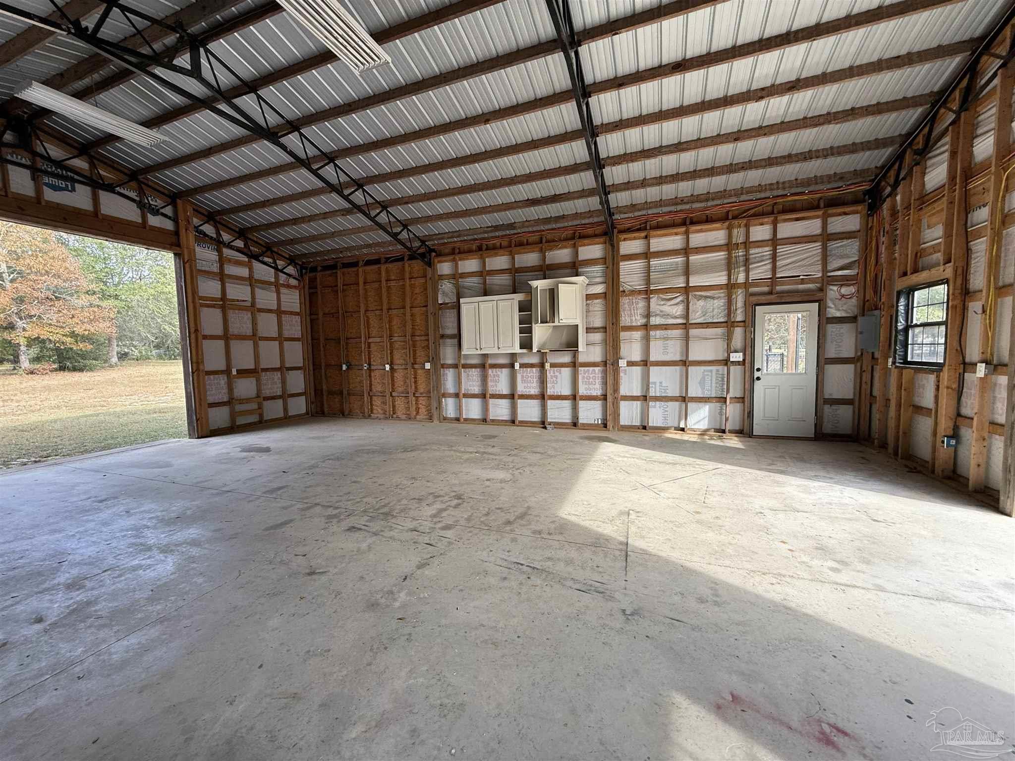 7223 Martin Road Milton, FL 32570 - Photo 6 of 28 a view of an empty room with a garage
