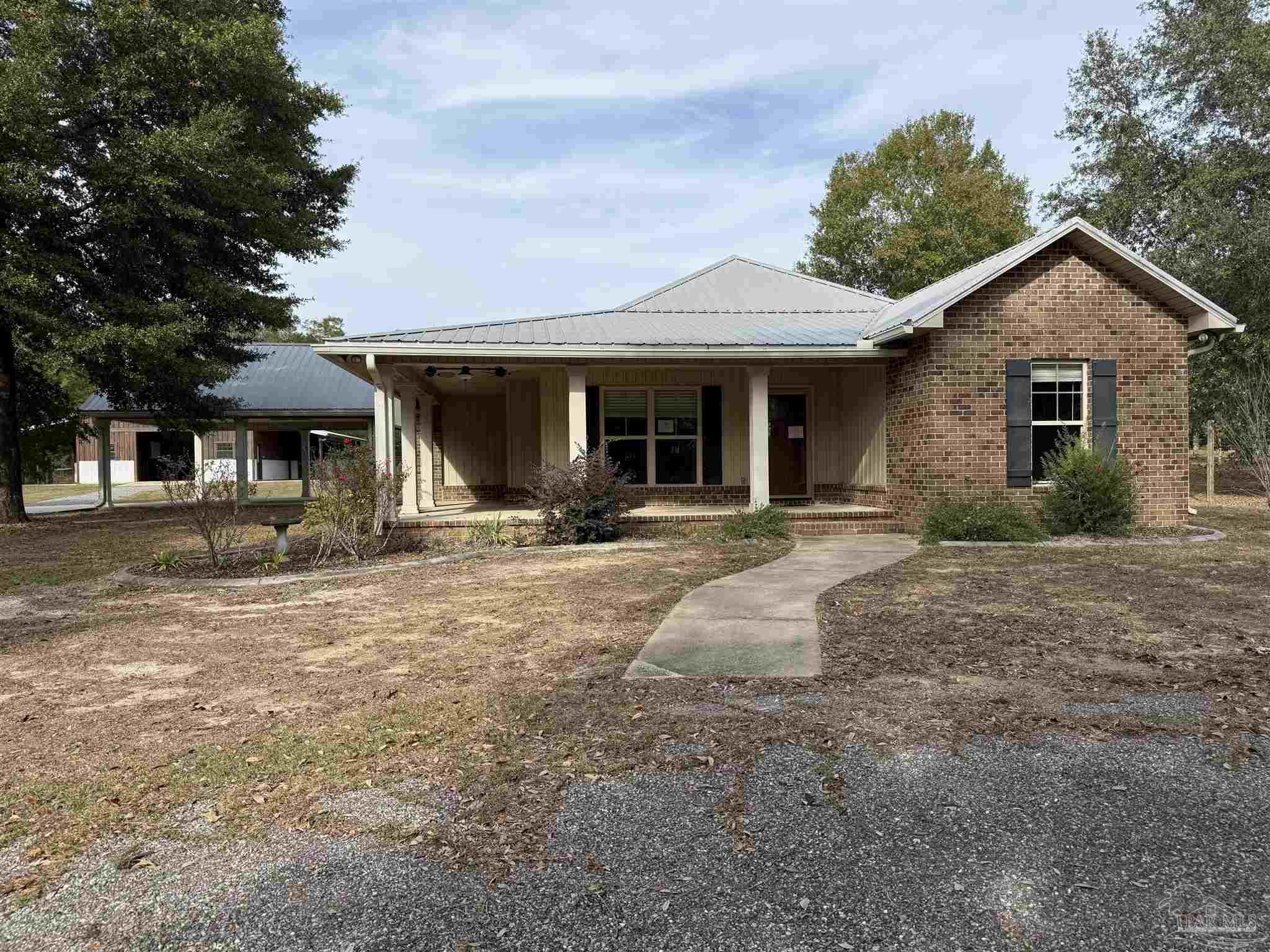 7223 Martin Road Milton, FL 32570 - Photo 8 of 28 a view of a house with backyard and trees