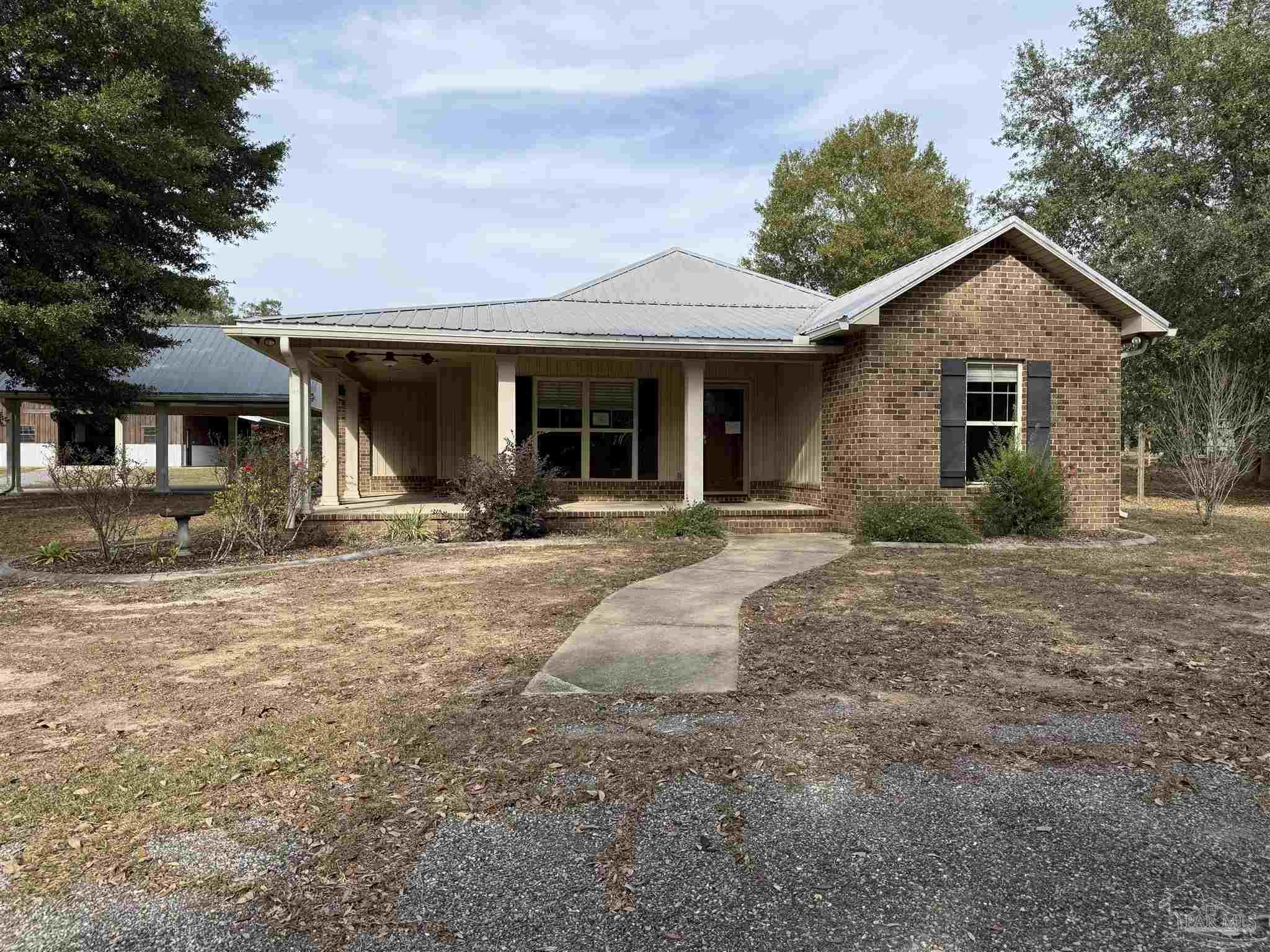7223 Martin Road Milton, FL 32570 - Photo 9 of 28 a front view of a house with yard and green space
