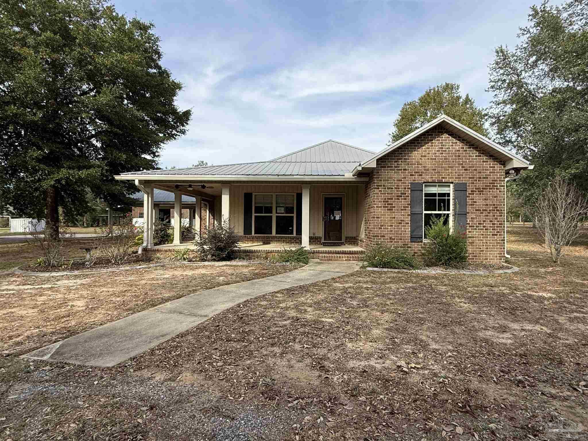 7223 Martin Road Milton, FL 32570 - Photo 10 of 28 a front view of a house with yard and green space