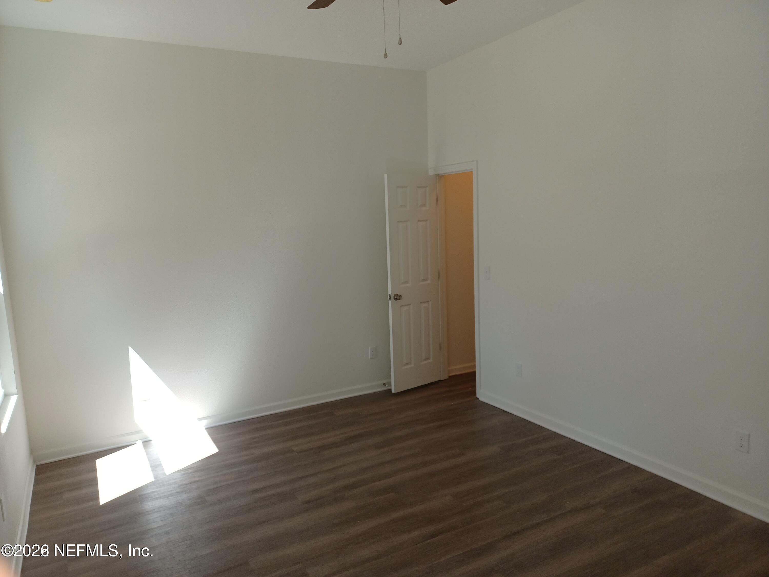 3006 Alonso Road Jacksonville, FL 32216 - Photo 6 of 16 a view of an empty room with wooden floor